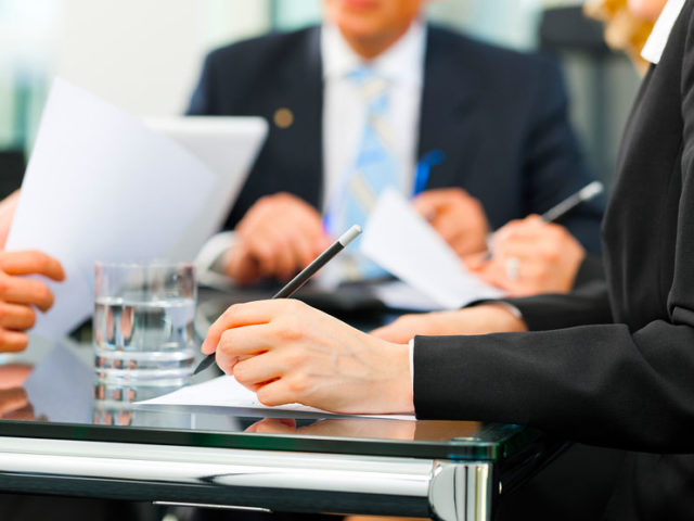 Business - meeting in an office, lawyers or attorneys discussing a document or contract agreement